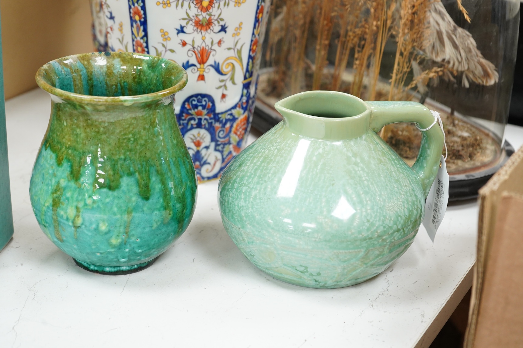 A group of Continental green glazed earthenware vessels including a crystal glazed jug, largest 29cm high
